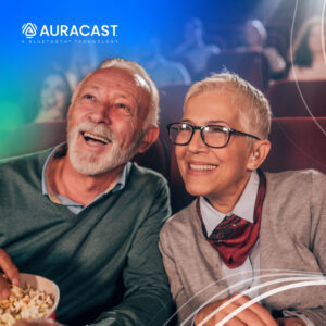 Couple enjoying a joyful movie night with popcorn in a cozy theater setting.