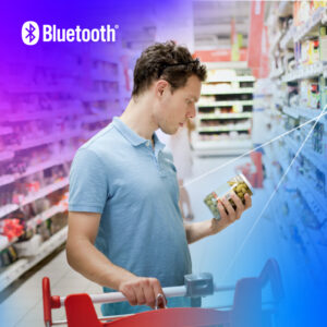 Young man in blue polo shirt evaluates pickles in a colorful grocery store aisle.
