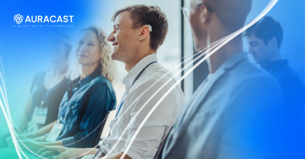 Three individuals in a professional setting, smiling and focused forward. One person in the middle is wearing a hearing aid. A logo reading "Auracast: A Bluetooth Technology" is in the top left corner.