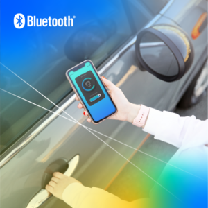 An overhead view of a person with one hand on a car door, showing a smartphone in the other hand unlocking the car door using a Bluetooth Channel Sounding enabled digital key.